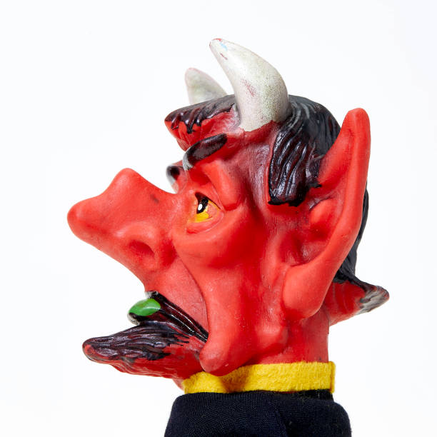 istock Vintage finger punch puppet, red devil, side view on white background 1143299179