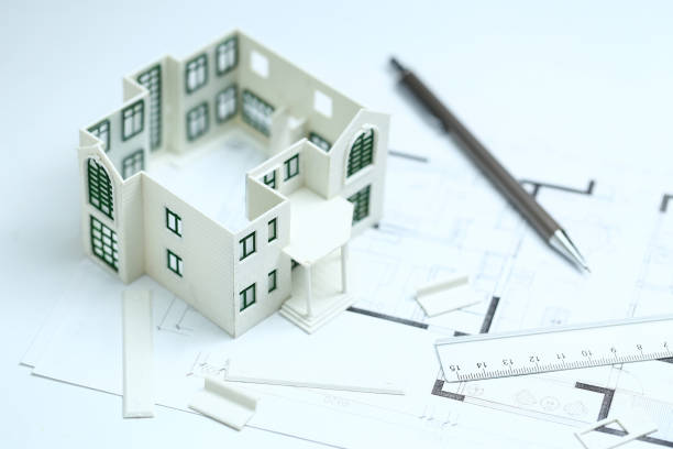 istock house model,blueprint,pencil and ruler on clean white background 1143299269