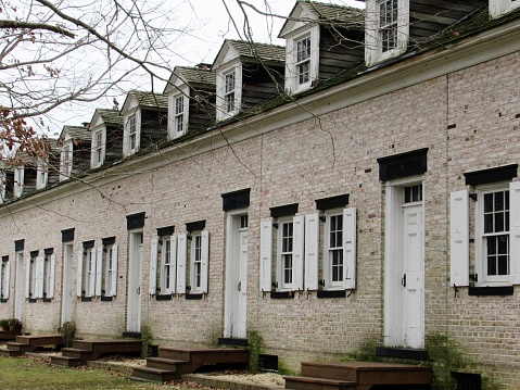 Row of lodgings at Allaire Village, New Jersey, USA. Allaire Village is a living history museum (free entrance). The village was established as a bog iron furnace originally known as Monmouth Furnace and then Howell Works. In 1822, it was purchased by philanthropist James P. Allaire, who endeavored to turn the furnace into a self-contained community.