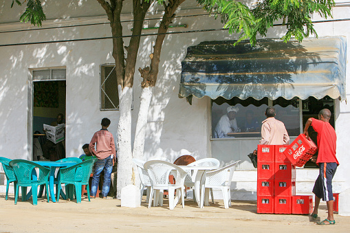 Massawa, Eritrea – Mai 12, 2011: People at a bar and restaurant in Ghinda village, on the road between Asmara in the highlands and Massawa on the Red Sea coast, in Eritrea. Ghinda is a major fruit and vegetable growing area and a center for Tigre Muslims.