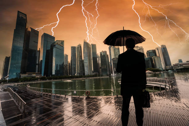 Businessman With Umbrella Looking Storm Over City Businessman With Umbrella Looking Storm Over City lightning storm natural disaster cloud stock pictures, royalty-free photos & images