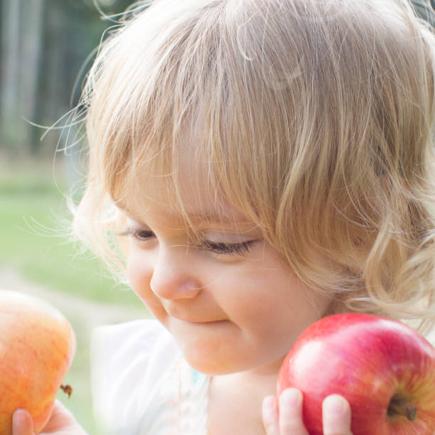 istock Baby with fruits 1143305092