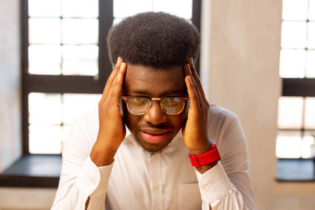 istock Unhappy cheerless young man holding his head 1143307961
