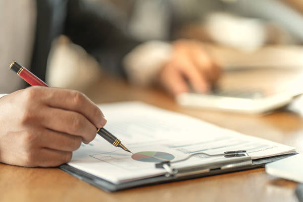 istock The accountant checking documents about graph and chart relating to financial reporting and tax accounting of the company 1143308711