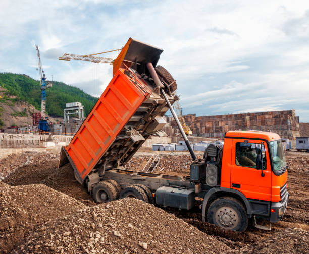 istock Dump truck unloads land at the construction site 1143312335