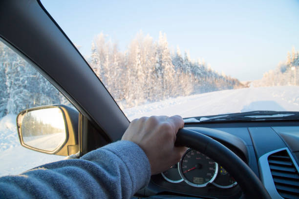 istock Driving a car on a winter road 1143314432