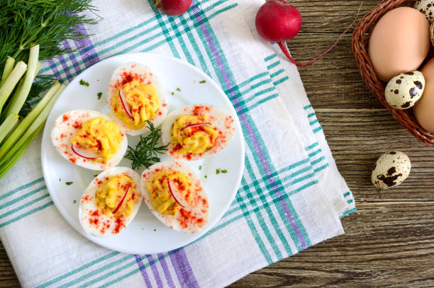 istock Deviled eggs. Delicious appetizer. Boiled eggs stuffed with yolk, mustard, mayonnaise, paprika. Classic recipe. The top view 1143314574