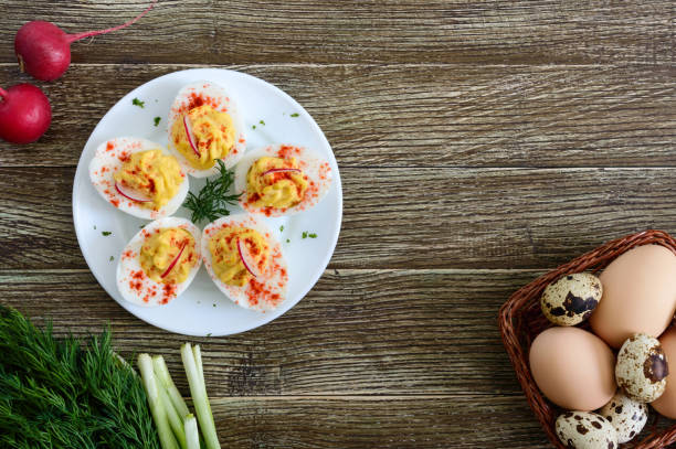 istock Deviled eggs. Delicious appetizer. Boiled eggs stuffed with yolk, mustard, mayonnaise, paprika. Classic recipe. The top view 1143314576