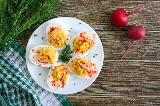 istock Deviled eggs. Delicious appetizer. Boiled eggs stuffed with yolk, mustard, mayonnaise, paprika. Classic recipe. The top view 1143314597