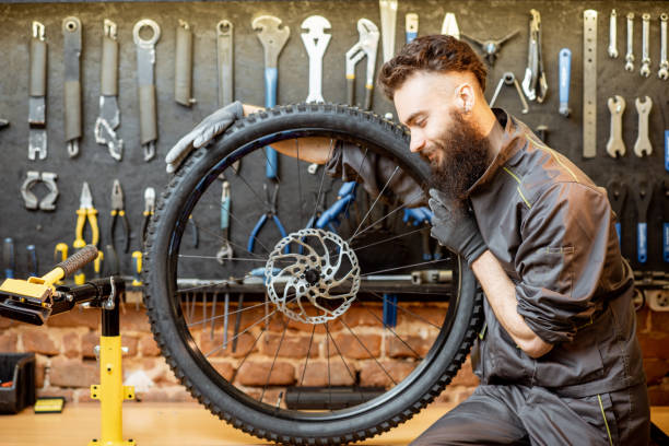 istock Reapairman with bicycle wheel in the workshop 1143316613