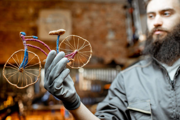 istock Man with toy bicycle at the workshop 1143317334