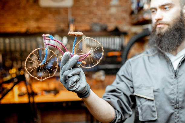 istock Man with toy bicycle at the workshop 1143317336