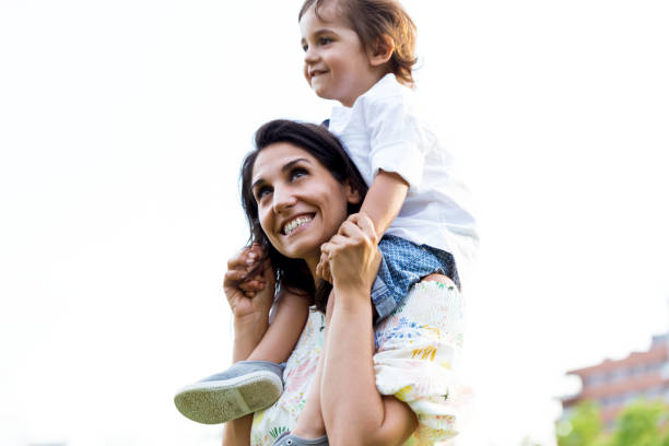 istock Beautiful young mother with her son having fun in the park. 1143317607