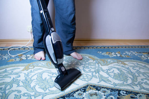 istock cleaning the floor with vacuum cleaner 1143318504
