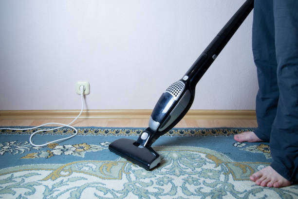 istock cleaning the floor with vacuum cleaner 1143319056