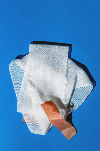 istock Bandage with tape on blue. Top view. 1143319126