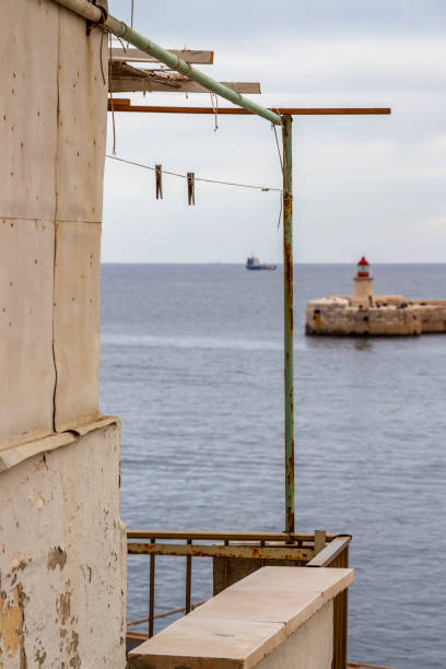 istock Ricasoli Breakwater Light and a ship at Grand Harbor, Malta 1143321515