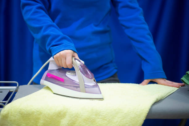 istock woman ironing clothes 1143321628
