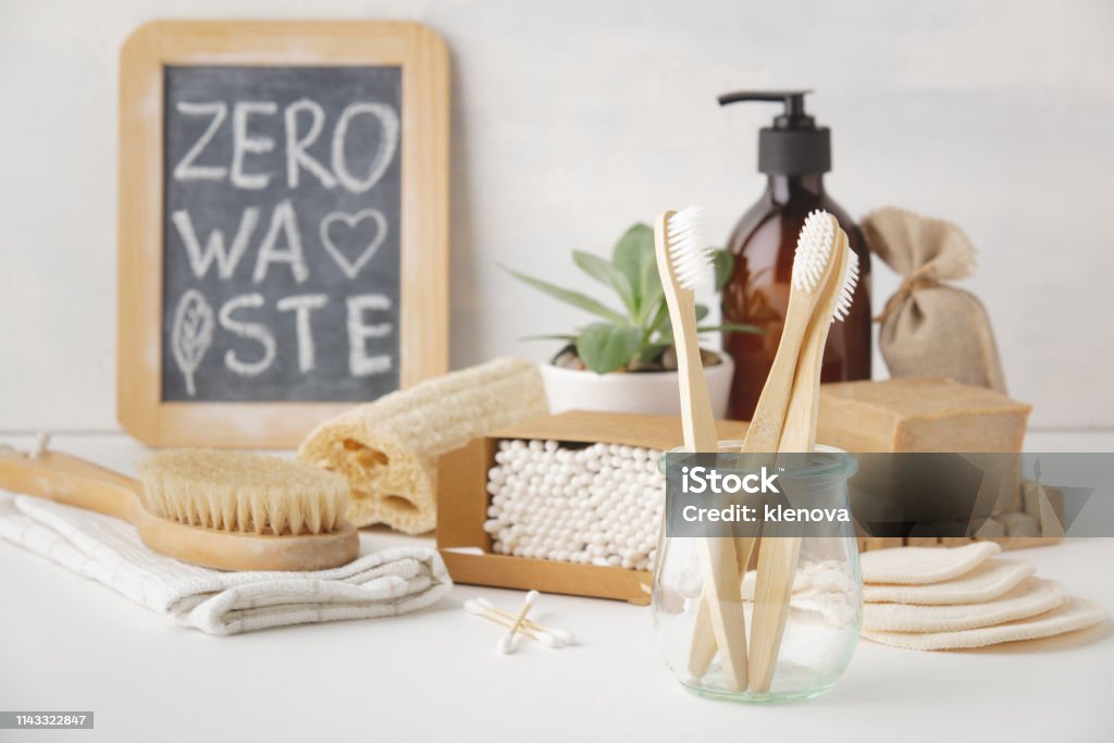 Zero waste concept. Eco-friendly bathroom accessories, copyspace Zero waste, Recycling, Sustainable lifestyle concept. Eco-friendly bathroom accessories: toothbrushes, reusable cotton make up removal pads, make up remover in a glass container, natural brushes, handmade soap, bamboo ear sticks Environmental Conservation Stock Photo