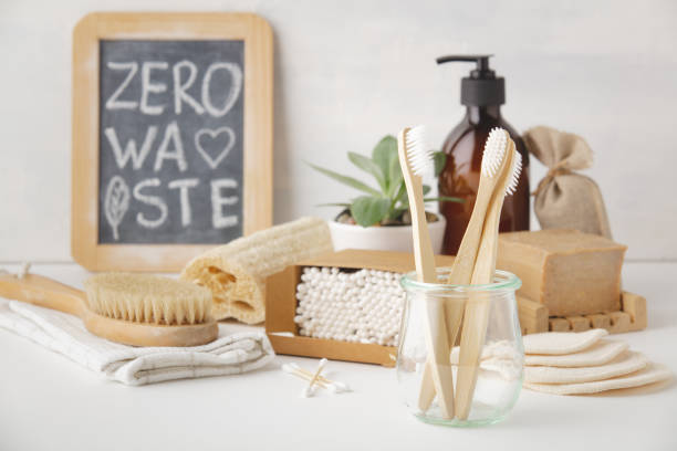 Zero waste concept. Eco-friendly bathroom accessories, copyspace Zero waste, Recycling, Sustainable lifestyle concept. Eco-friendly bathroom accessories: toothbrushes, reusable cotton make up removal pads, make up remover in a glass container, natural brushes, handmade soap, bamboo ear sticks bamboo material photos stock pictures, royalty-free photos & images