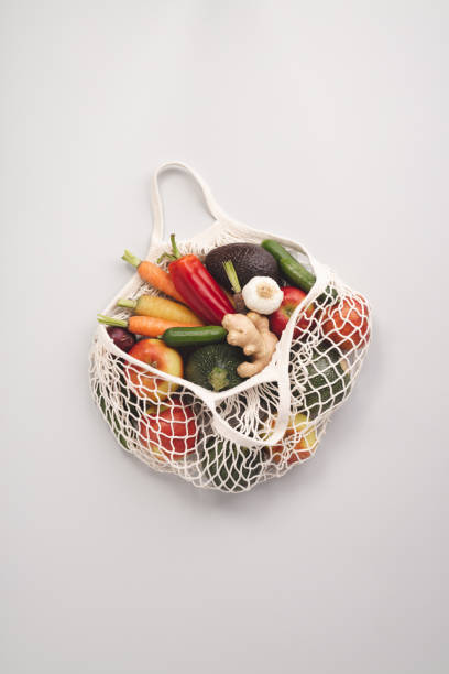 istock Fresh organic fruits and vegetables in mesh textile bag 1143323033