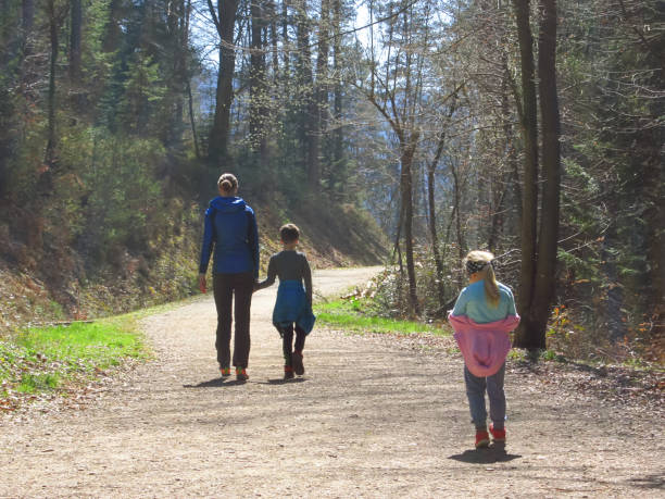 istock Mother with kids hiking in forest 1143326022