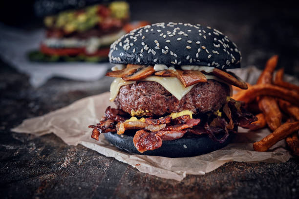 istock Black Burger Buns with Beef Pattie, Cheese, Bacon and Mushrooms 1143326030