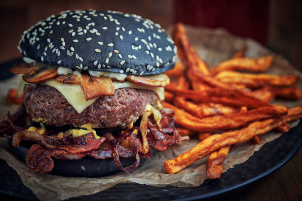 istock Black Burger Buns with Beef Pattie, Cheese, Bacon and Mushrooms 1143326115