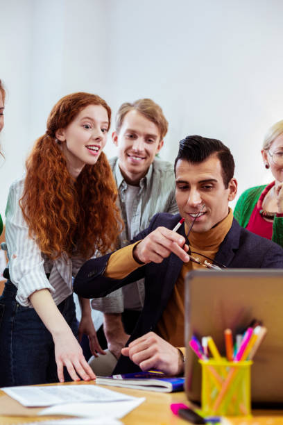 istock Handsome young man pointing at the laptop screen 1143326349