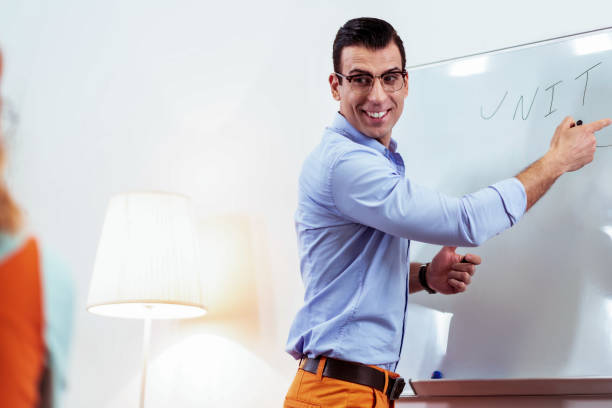 istock Joyful professional teacher smiling to his student 1143326534