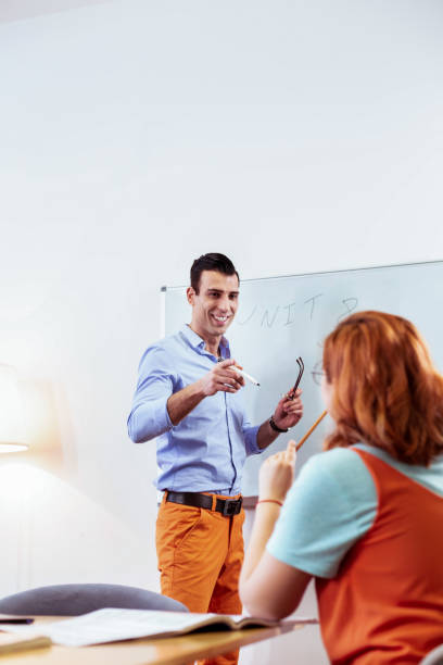 istock Delighted positive man pointing at this student 1143326658