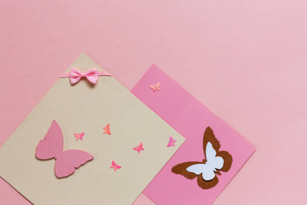 istock Butterfliy figyrines on the pink paper background 1143328743