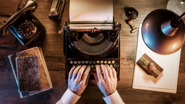 journalist working in his vintage office at night - writing typewriter 1950s style retro revival imagens e fotografias de stock