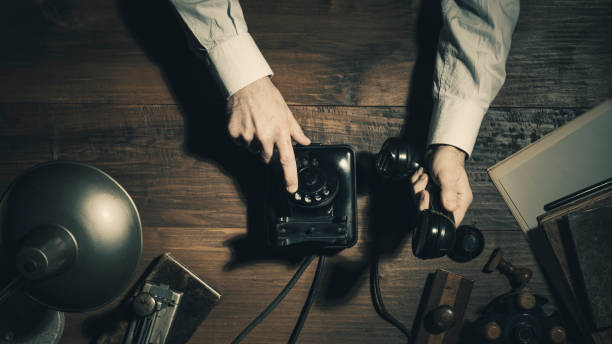 istock Office worker making a phone call late at night in a vintage office 1143329983
