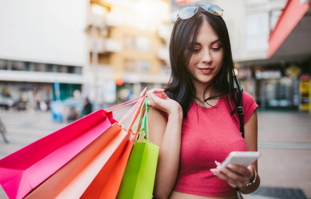 istock Using phone with shopping bags 1143332206