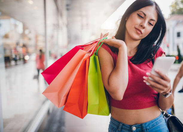 istock Using phone with shopping bags 1143332245