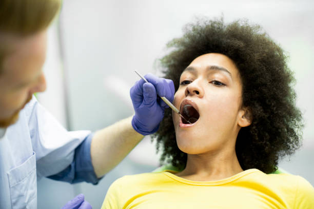 istock Dentist using a mouth mirror to perform a dental check up 1143332263