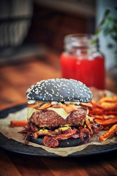 istock Black Burger Buns with Beef Pattie, Cheese, Bacon and Mushrooms 1143332306
