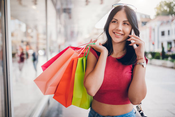 istock Using phone with shopping bags 1143332310