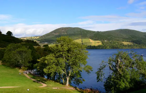 Scotland's rolling green hills surrounding the intriquing Loch Ness.