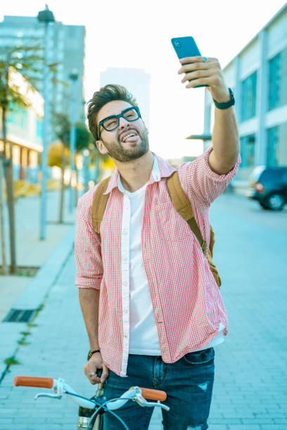 istock Young man with bike and smart phone 1143336585