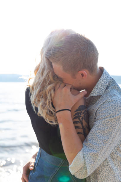 istock Couple in romantic embrace on beach in summer 1143338250