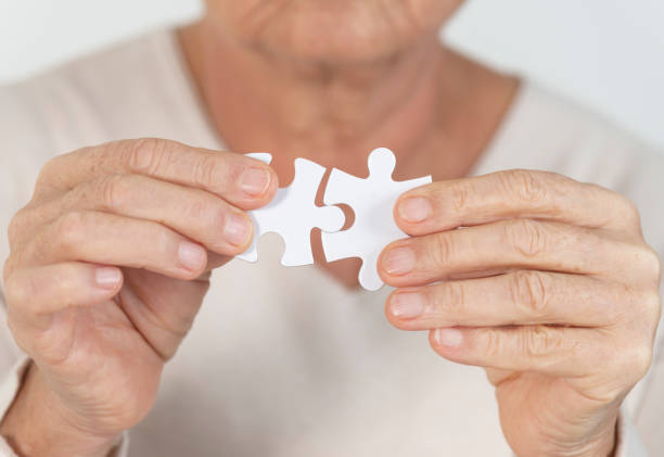 istock Elderly woman with puzzle 1143338395