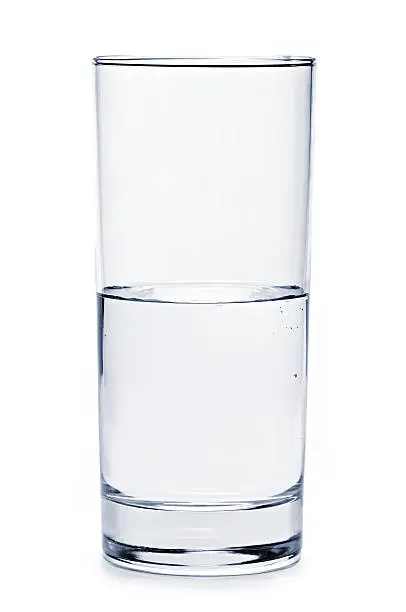 Glass of water half empty isolated on white background