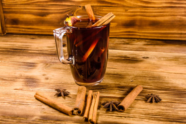 istock Cup of mulled wine with cinnamon on wooden table 1143339635