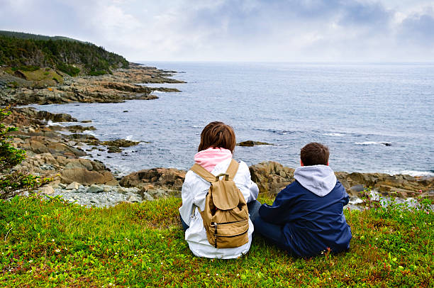 istock Children sitting at Atlantic coast in Newfoundland 114333980