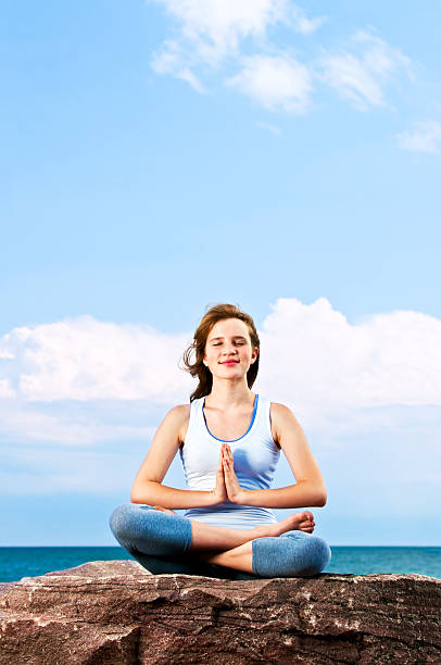 istock Young girl meditating outdoors 114334213