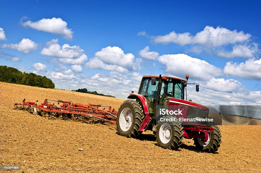 Tractor en el campo arado - Foto de stock de Granja libre de derechos