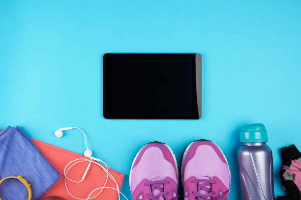 istock electronic tablet with a blank black screen, next to it is fitness clothes 1143347854