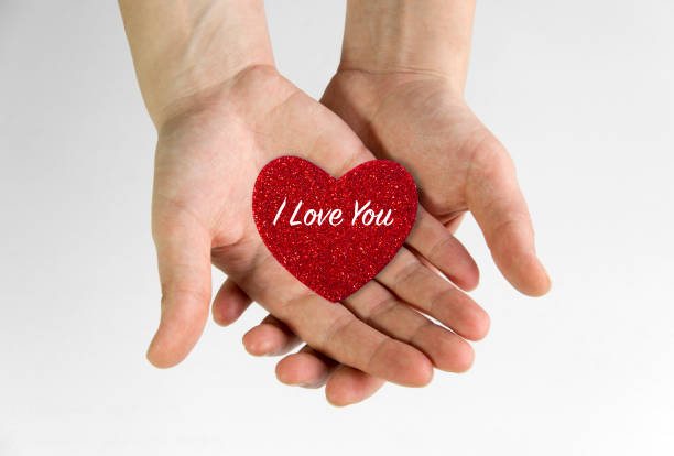 istock Red heart holding in hands 1143349674